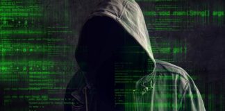 Faceless hooded anonymous computer hacker