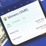 Monero XMR Cryptocurrency Buy Button On The Screen, Using A Smartphone For Buiyng Crypto Coins Concept